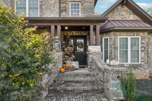 a front view of a house with outdoor seating