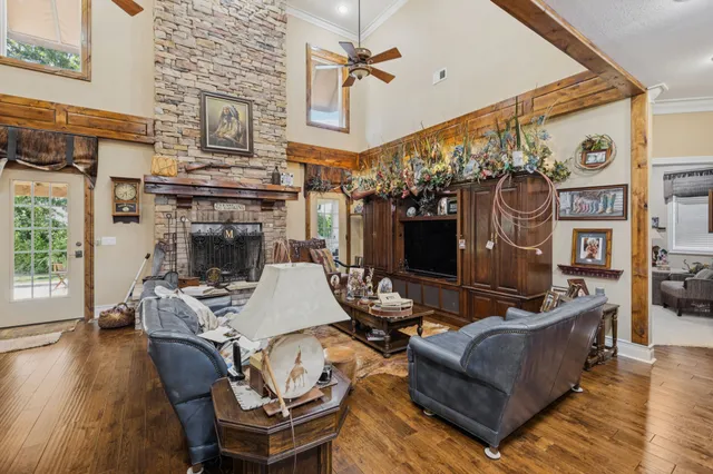 a living room with furniture a flat screen tv and a fireplace