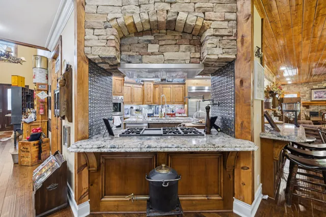a view of a kitchen with a sink and a wooden floor