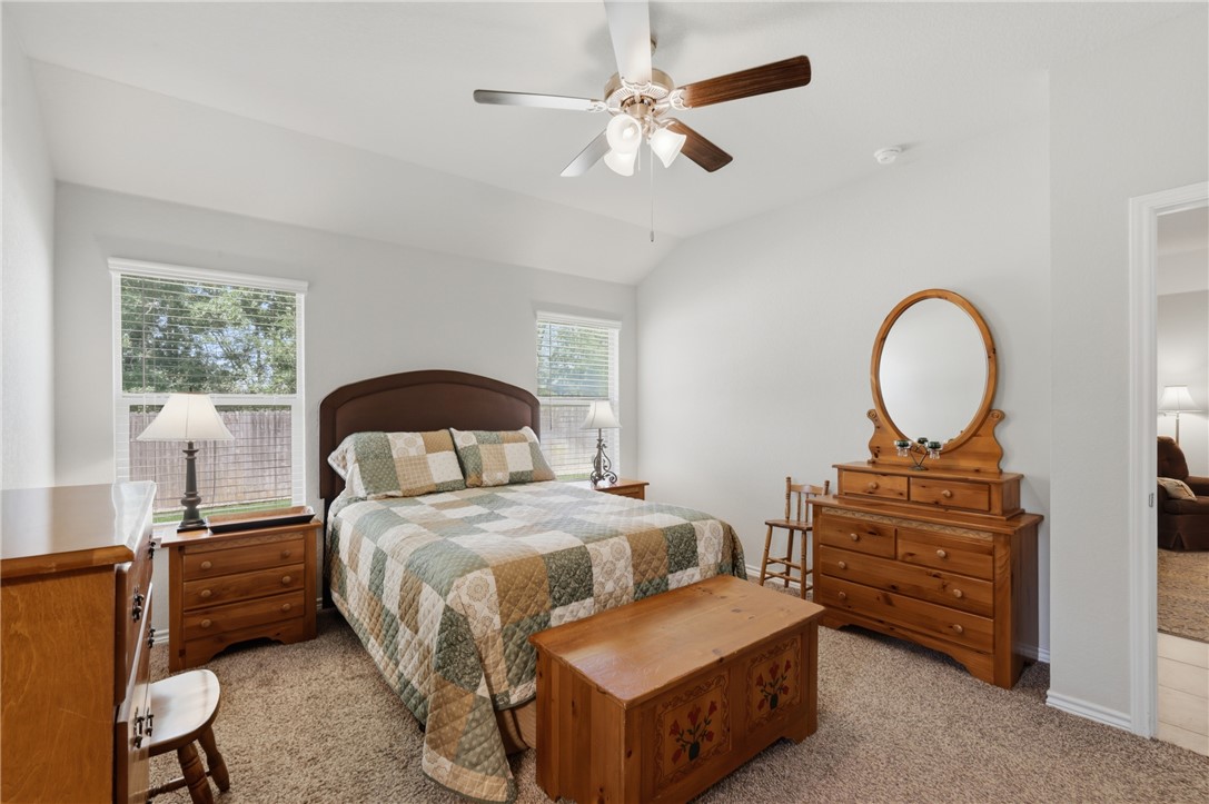 1943 Thorndyke Lane Bryan, TX 77807 - Photo 20 of 28 Oversized primary bedroom with serene views of the greenbelt behind the home.