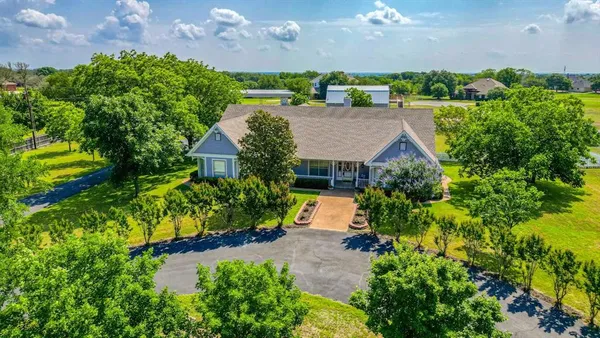an aerial view of a house with a yard outdoor seating and entertaining space
