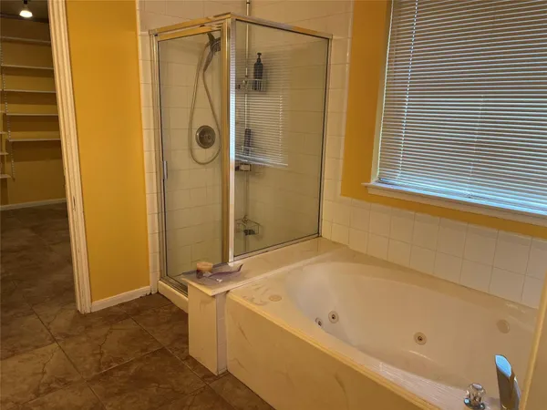 a bathroom with a tub and a shower