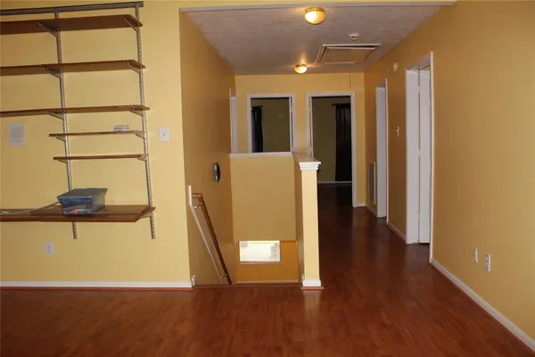 a view of a room with wooden floor and cabinet