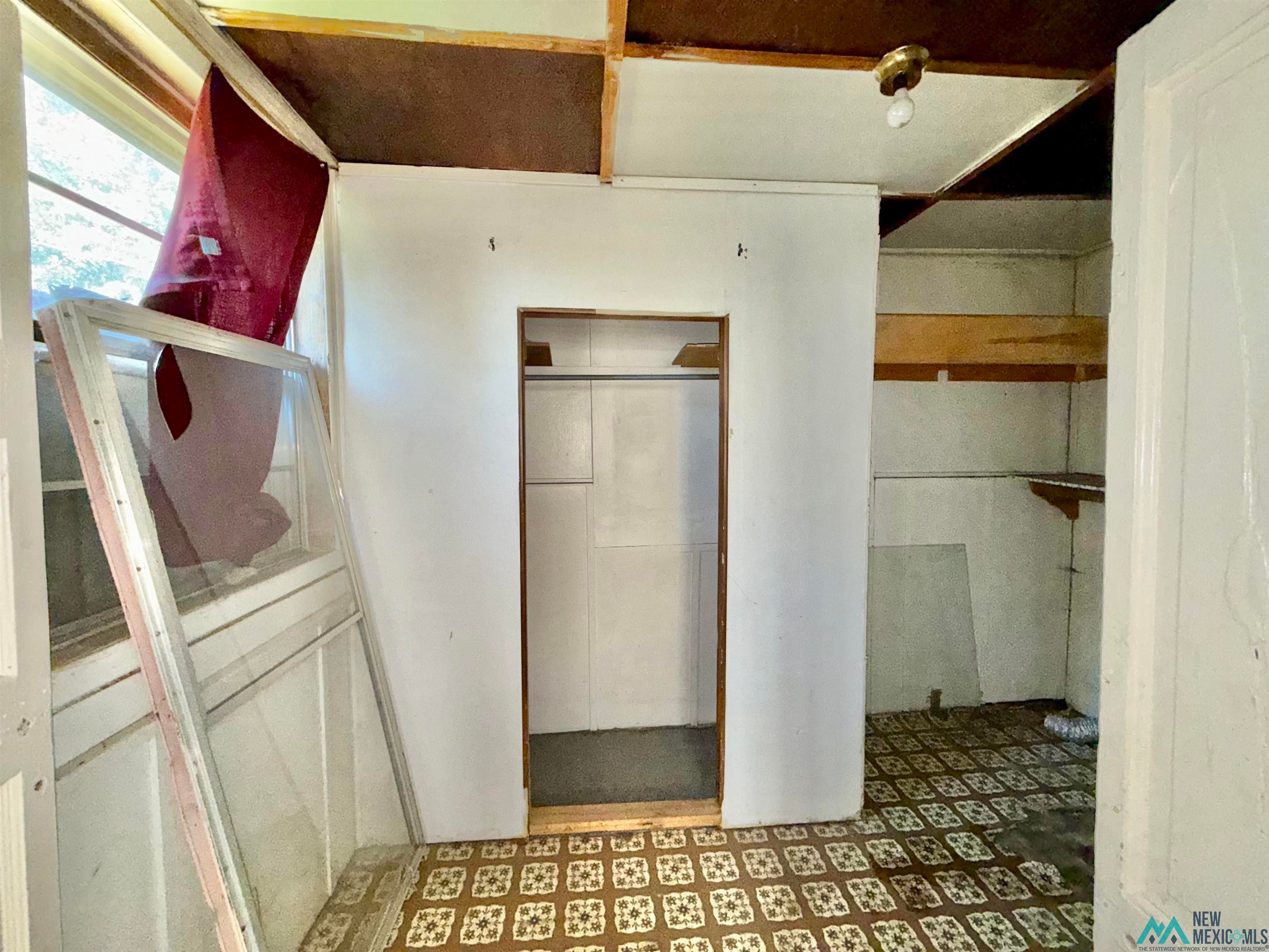 237 Vermejo Street Raton, NM 87740 - Photo 8 of 14 Hallway with tile patterned floors