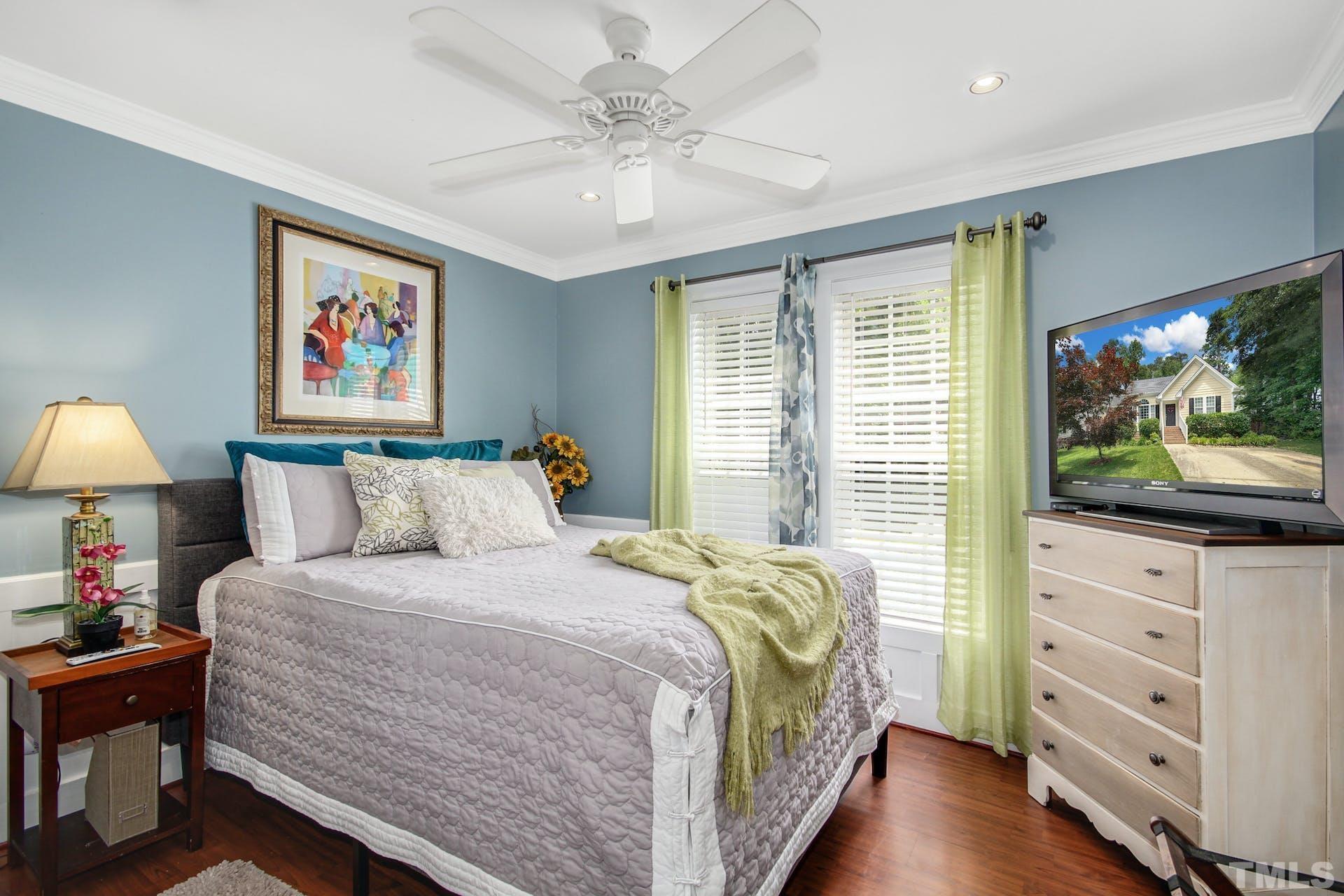 103 Lemon Drop Circle Apex, NC 27502 - Photo 16 of 20 a bedroom with a bed and a flat screen tv