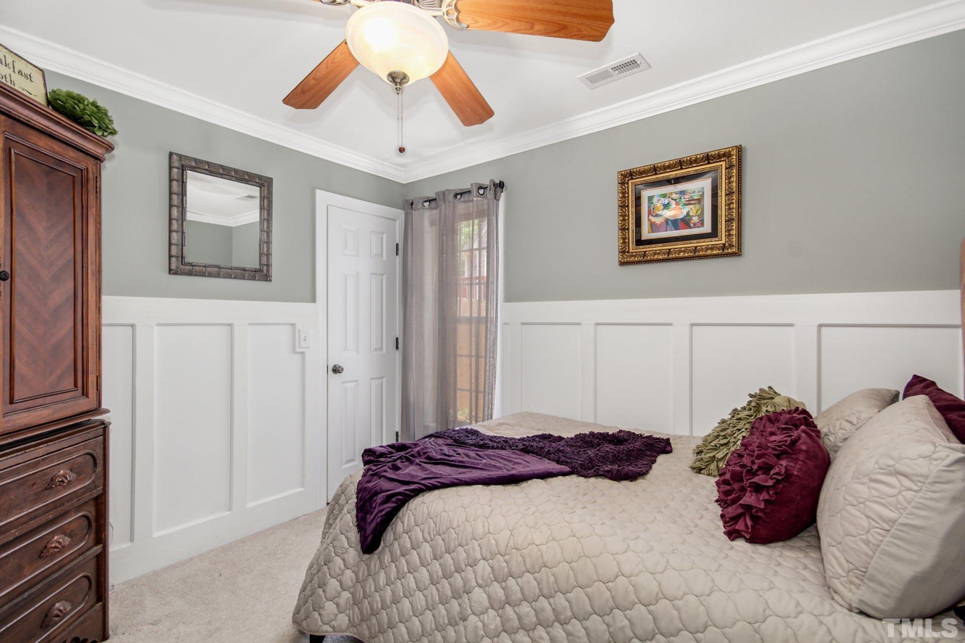103 Lemon Drop Circle Apex, NC 27502 - Photo 17 of 20 a bedroom with a large bed and a chandelier
