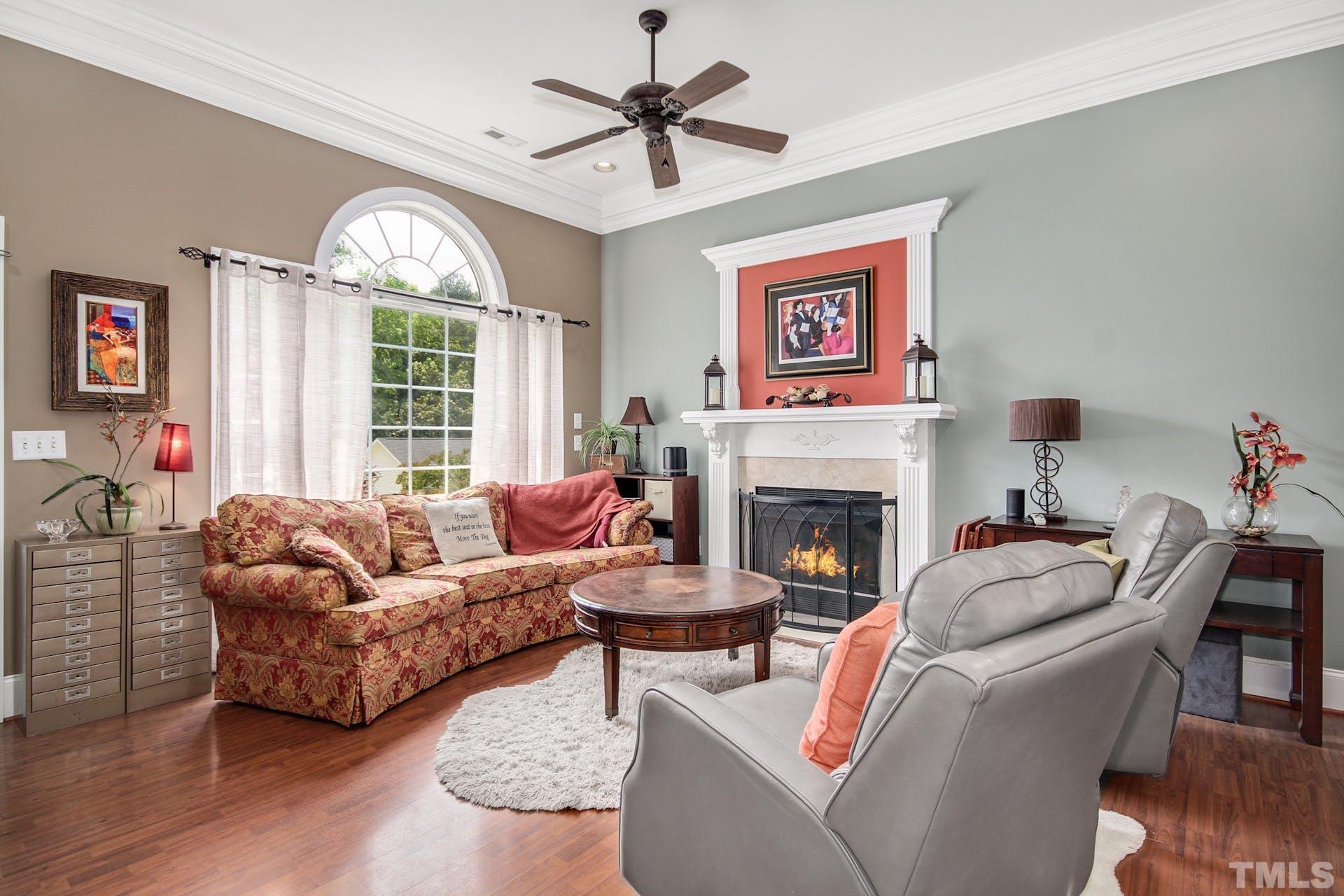 103 Lemon Drop Circle Apex, NC 27502 - Photo 5 of 20 a living room with furniture a fireplace and a large window