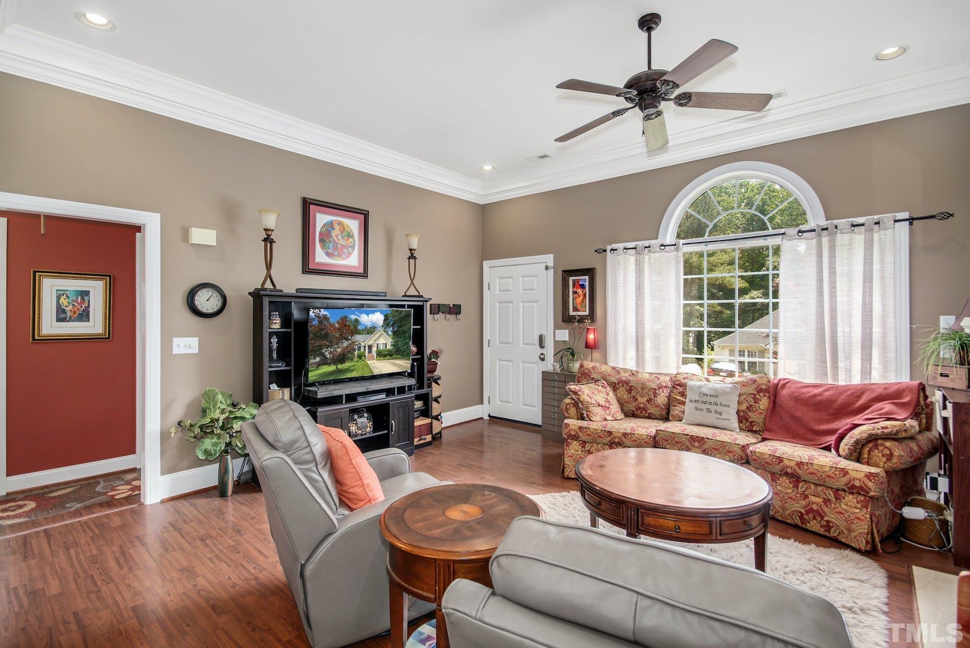 103 Lemon Drop Circle Apex, NC 27502 - Photo 6 of 20 a living room with furniture a window and a flat screen tv