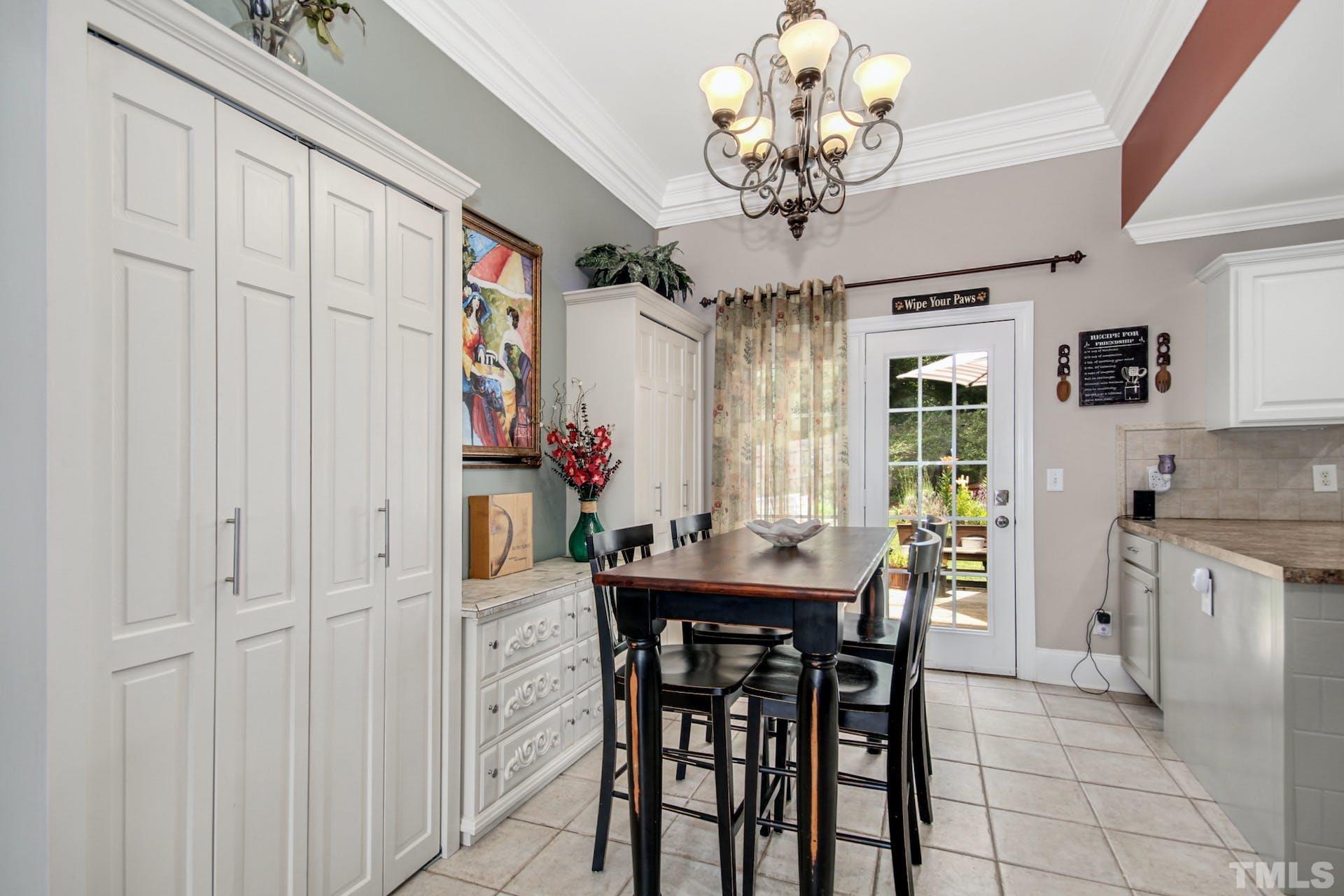 103 Lemon Drop Circle Apex, NC 27502 - Photo 7 of 20 a dining room with furniture and chandelier