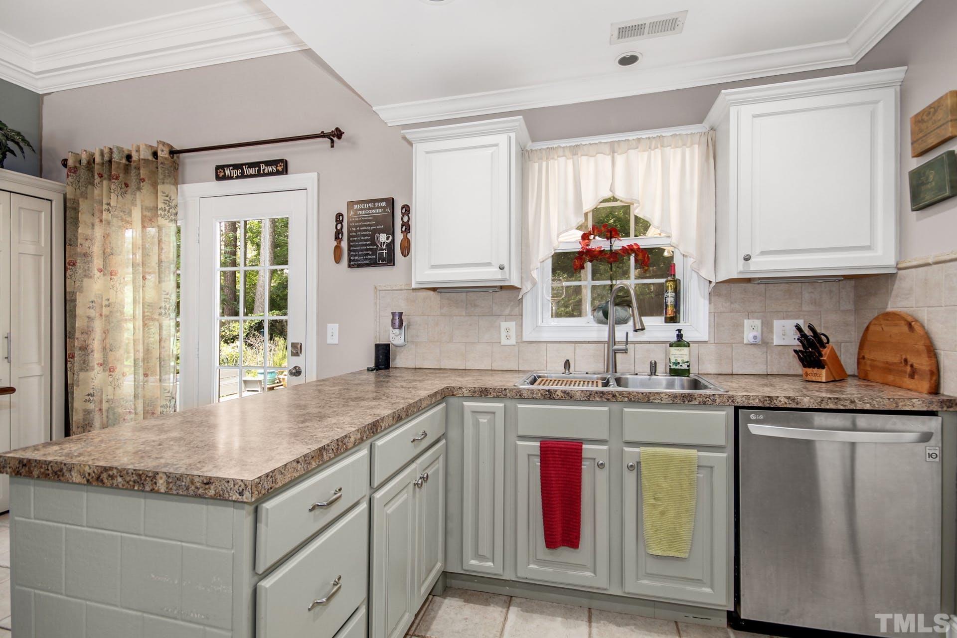 103 Lemon Drop Circle Apex, NC 27502 - Photo 10 of 20 a kitchen with stainless steel appliances granite countertop a sink stove and cabinets