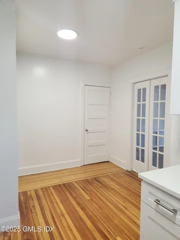 a view of a room with wooden floor and cabinet