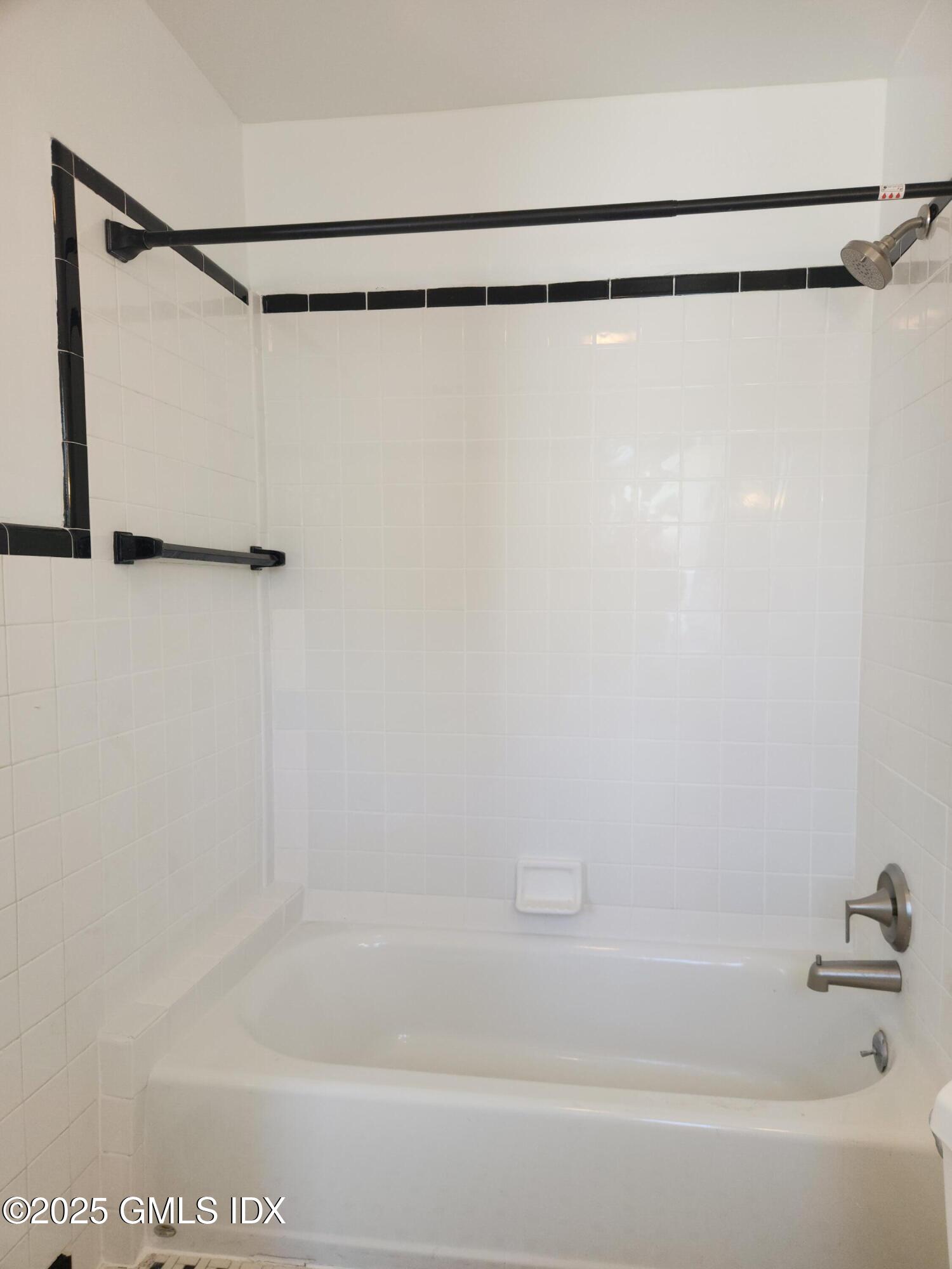 15 Scofield Street, Unit 1F Cos Cob, CT 06807 - Photo 13 of 15 a bathroom with a shower and a bath tub