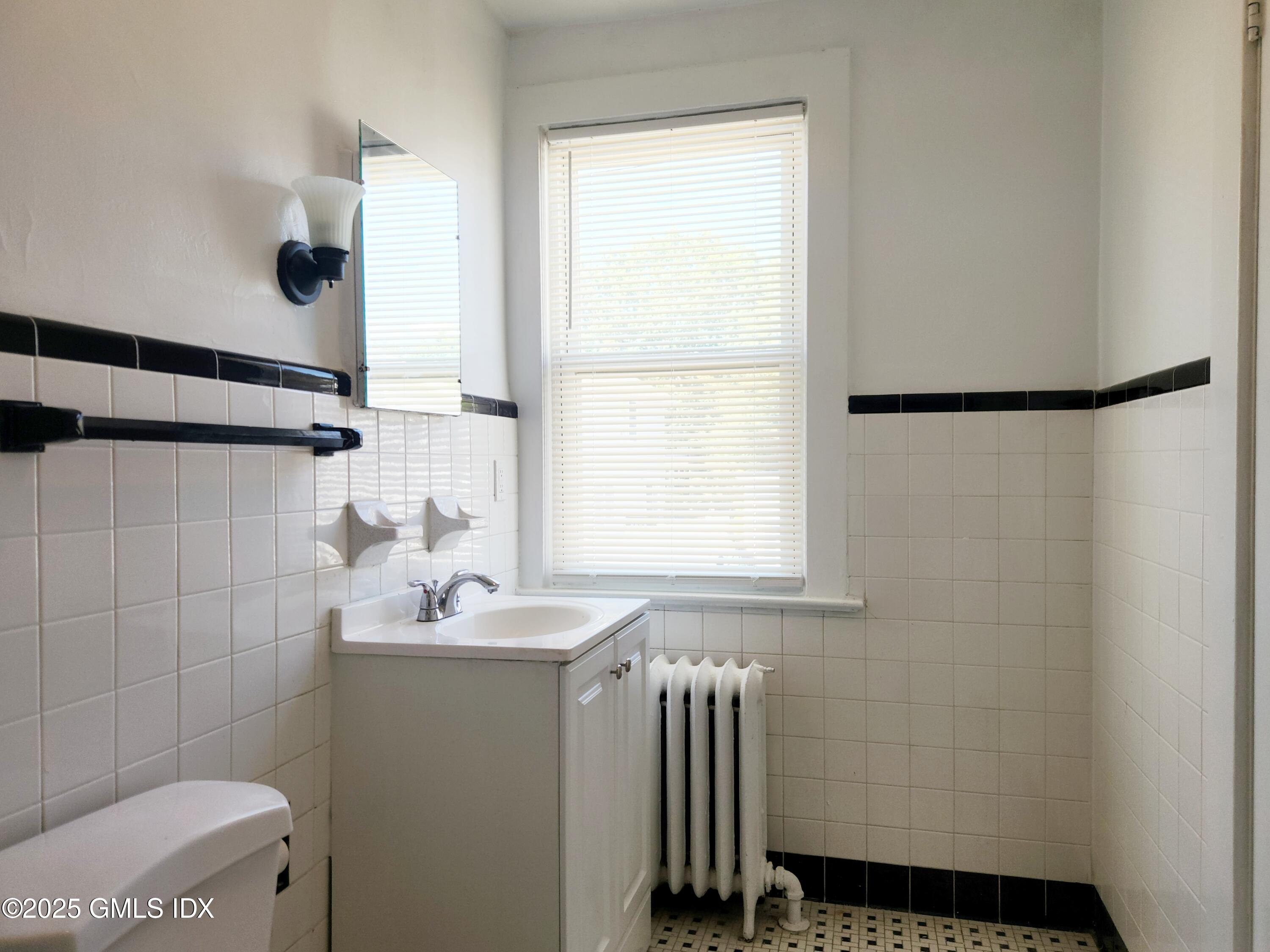 15 Scofield Street, Unit 1F Cos Cob, CT 06807 - Photo 14 of 15 a bathroom with a sink and a mirror
