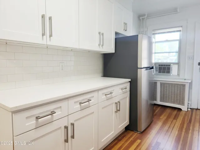 a kitchen with cabinets and a wooden floor