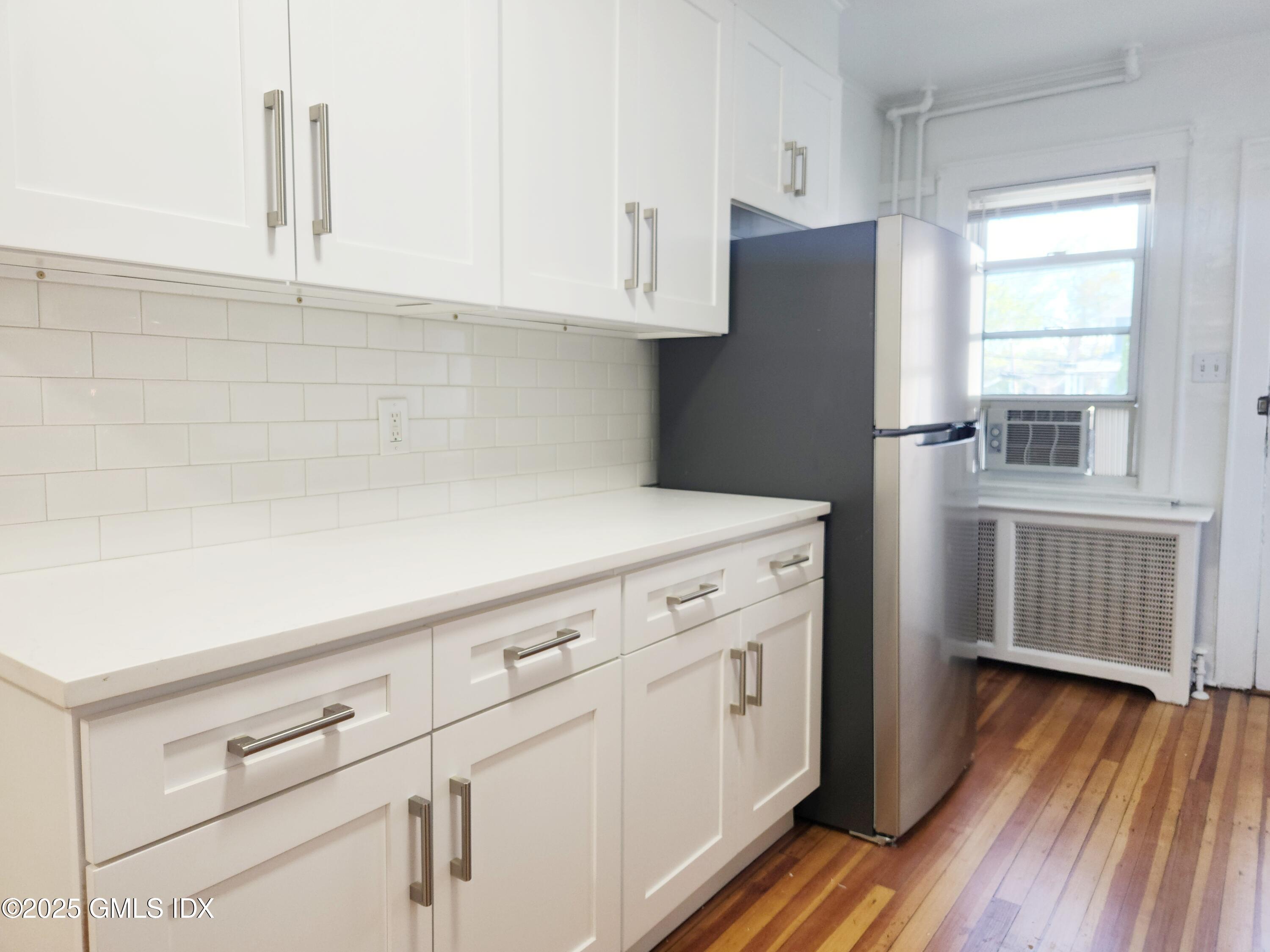 15 Scofield Street, Unit 1F Cos Cob, CT 06807 - Photo 3 of 15 a kitchen with cabinets and a wooden floor