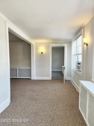 a view of an empty room with a fireplace