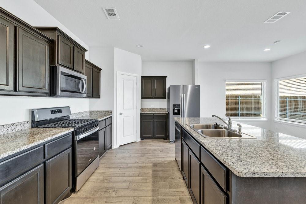 9632 Cherryville Road Fort Worth, TX 76108 - Photo 14 of 40 Stainless steel appliances and the side by side refrigerator stays!