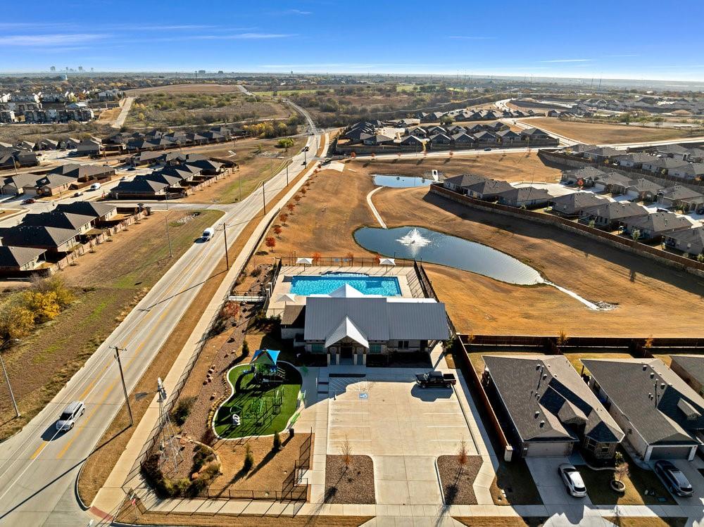 9632 Cherryville Road Fort Worth, TX 76108 - Photo 37 of 40 Amenity center is right behind the home, with a gorgeous view of the pond and water fountain! Playground and pool are a short walk away!
