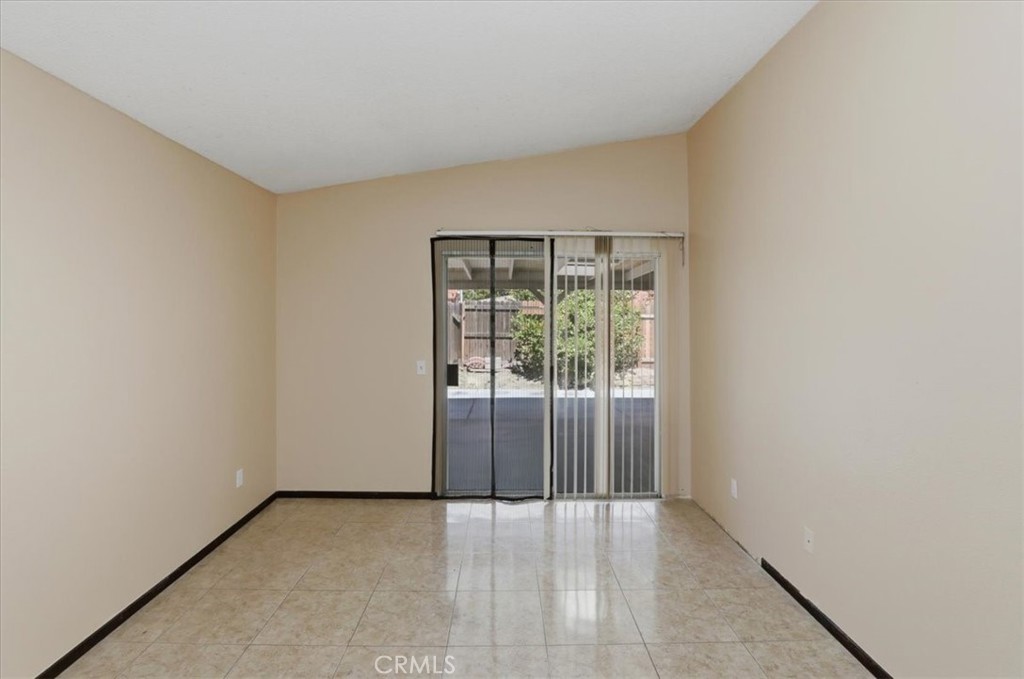 1907 Overland Street Colton, CA 92324 - Photo 15 of 36 an empty room with wooden floor and windows