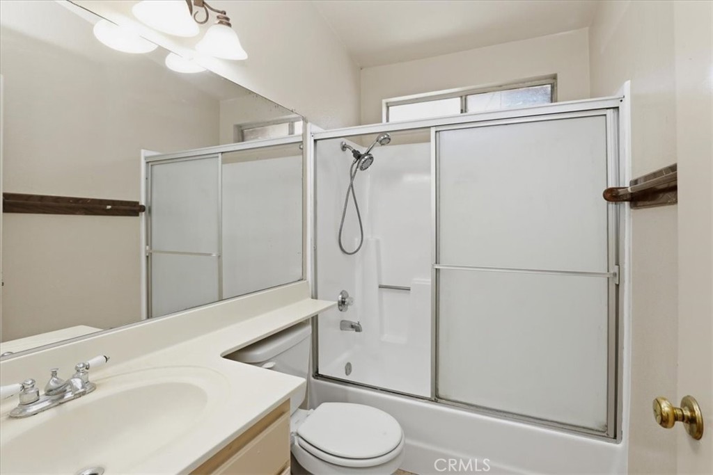 1907 Overland Street Colton, CA 92324 - Photo 16 of 36 a bathroom with a granite countertop sink toilet and shower
