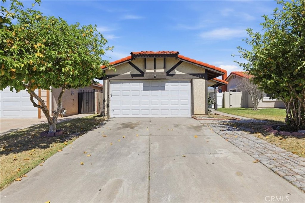 1907 Overland Street Colton, CA 92324 - Photo 4 of 36 a front view of a house with a yard and garage