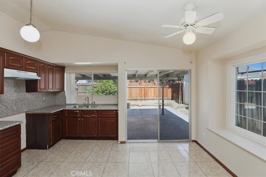 1907 Overland Street Colton, CA 92324 - Photo 7 of 36 a view of kitchen with granite countertop a sink cabinets and stainless steel appliances