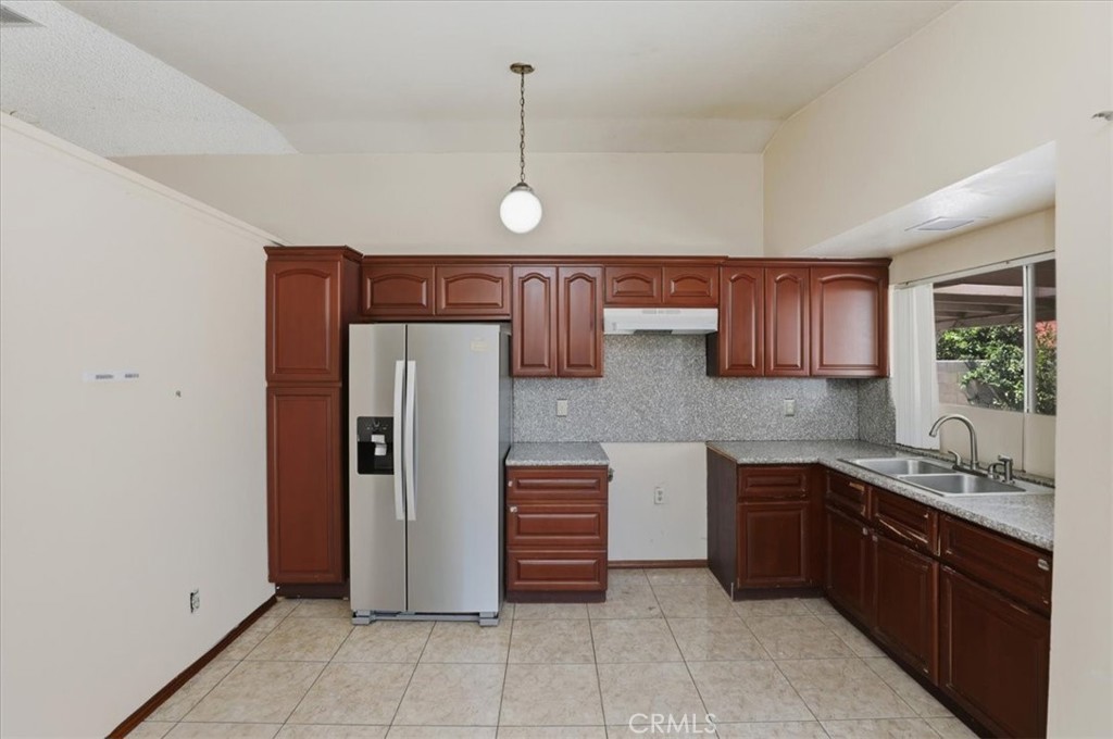 1907 Overland Street Colton, CA 92324 - Photo 8 of 36 a kitchen with stainless steel appliances granite countertop a refrigerator and a sink