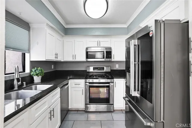 a kitchen with a sink stove and microwave