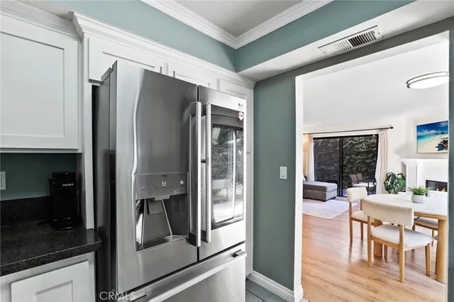 a living room with a large window and stainless steel appliances