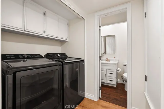 a view of bathroom with bathtub and white cabinet
