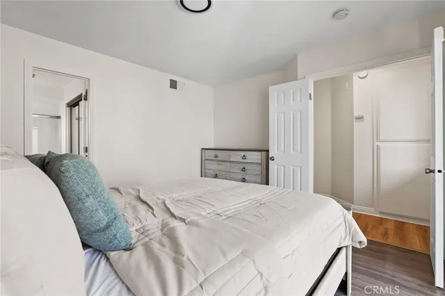 a bedroom with a bed and a dresser