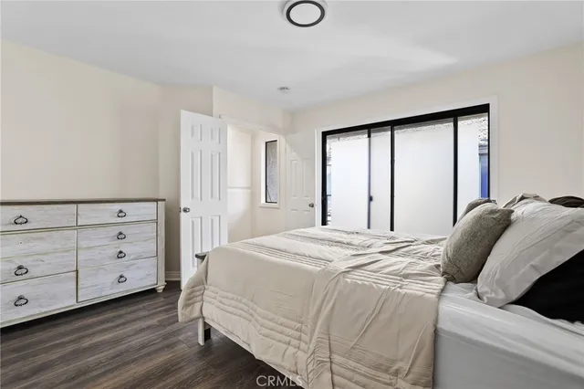 a bedroom with a bed and a dresser