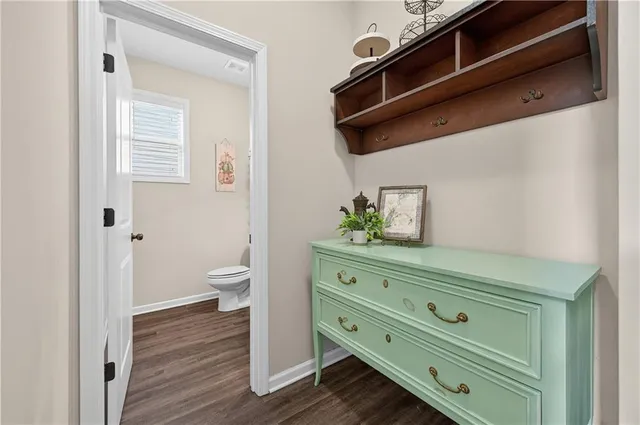 a bathroom with a toilet a sink and mirror
