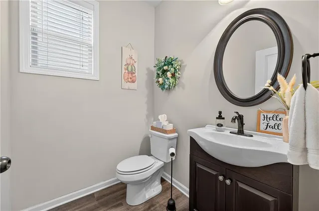 a bathroom with a toilet a sink and a mirror