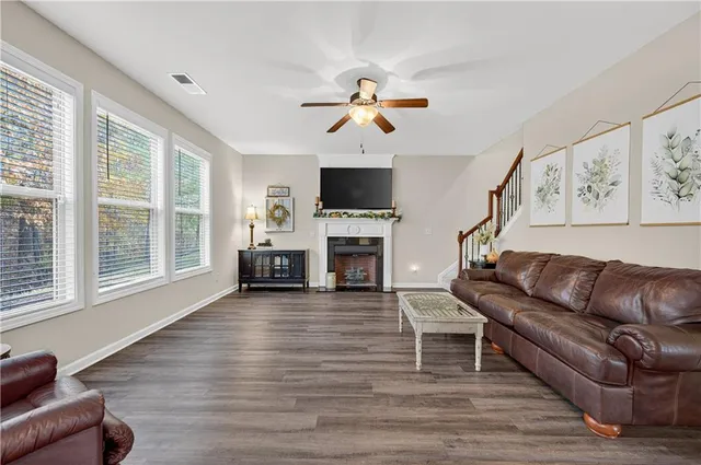 a living room with furniture a fireplace and a flat screen tv
