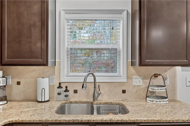 a kitchen with granite countertop a sink and a window