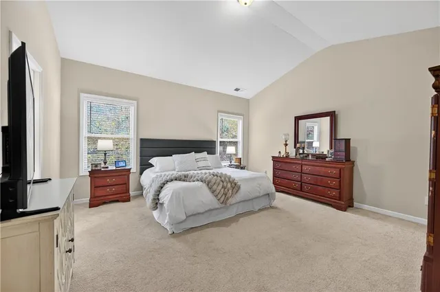 a bedroom with a bed and a dresser in it
