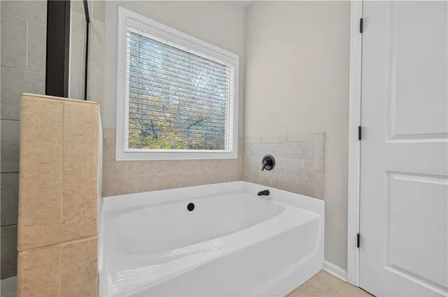 a white bath tub sitting next to a window