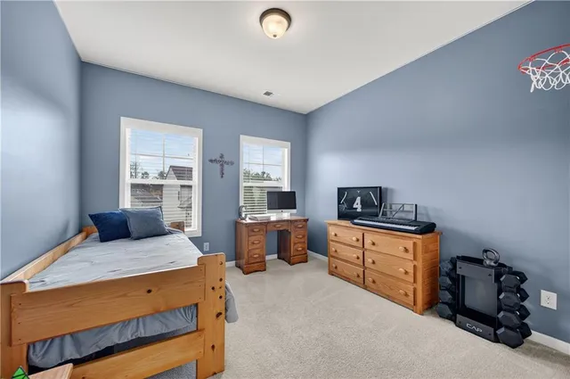 a bedroom with a bed and a desk