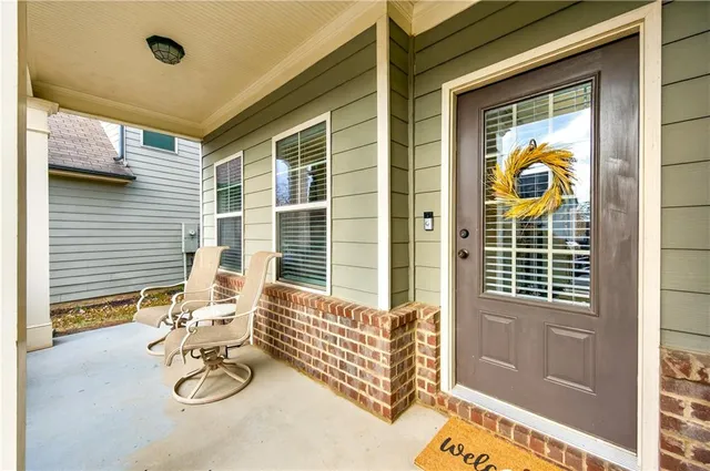 a view of a porch with a table and chairs