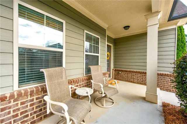 a view of a patio with table and chairs and wooden floor