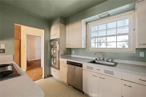 a kitchen with a sink cabinets and window