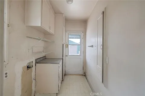 a utility room with cabinets washer and dryer
