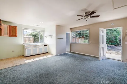 an empty room with closet and windows
