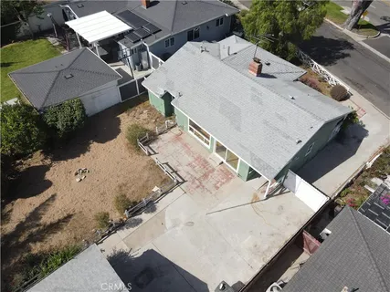 a aerial view of a house with a yard and sitting area