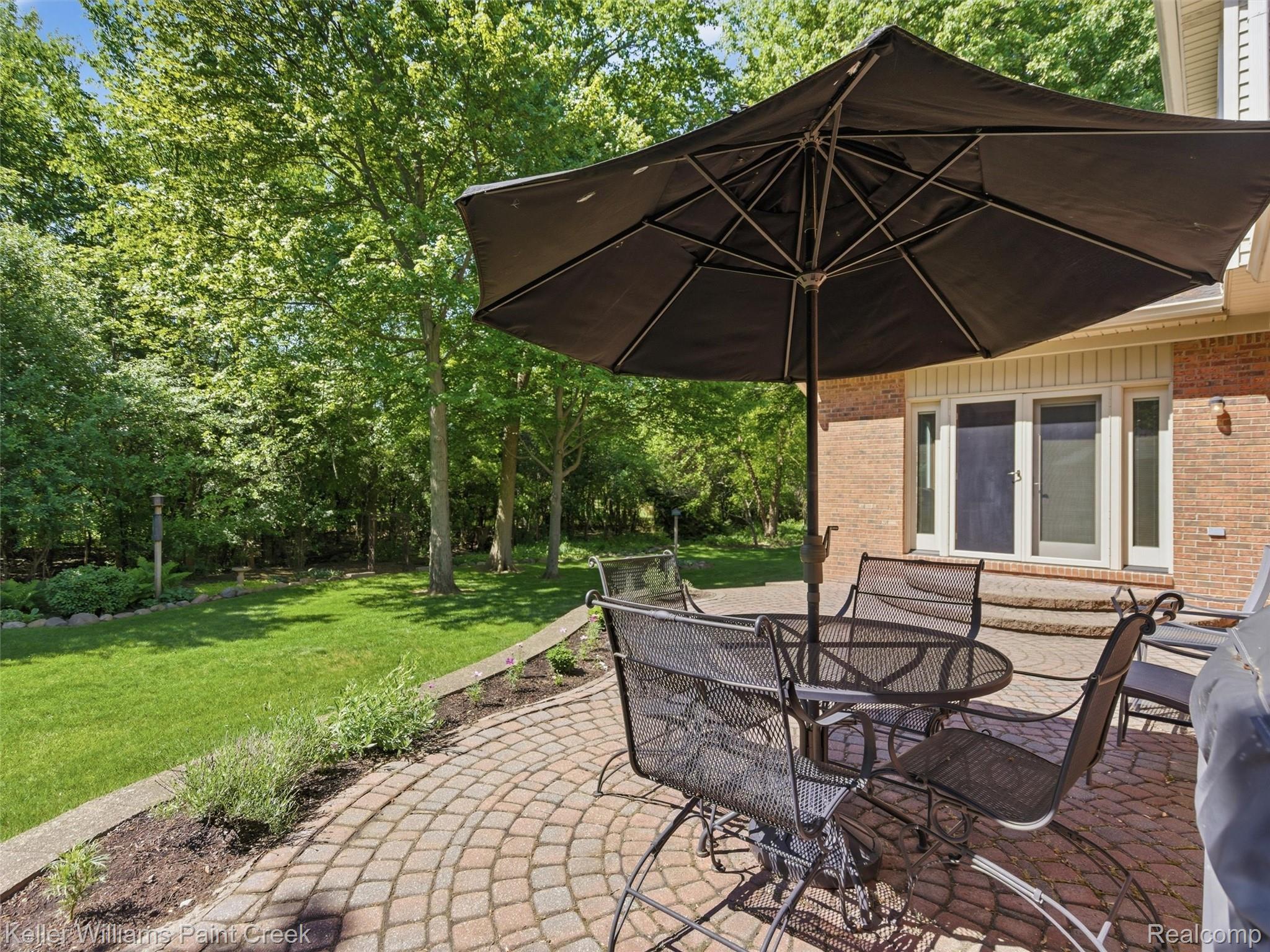 2842 Manorwood Road Troy, MI 48085 - Photo 70 of 72 Brick exterior with a paver patio and a raised planting bed