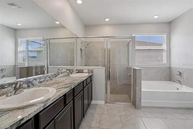 a bathroom with a granite countertop sink a toilet and shower