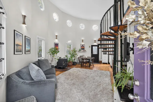 a living room with furniture and a potted plant