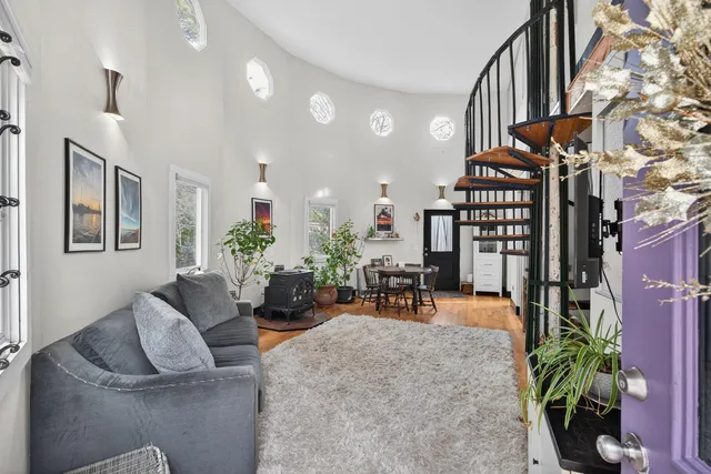 a living room with furniture and a potted plant