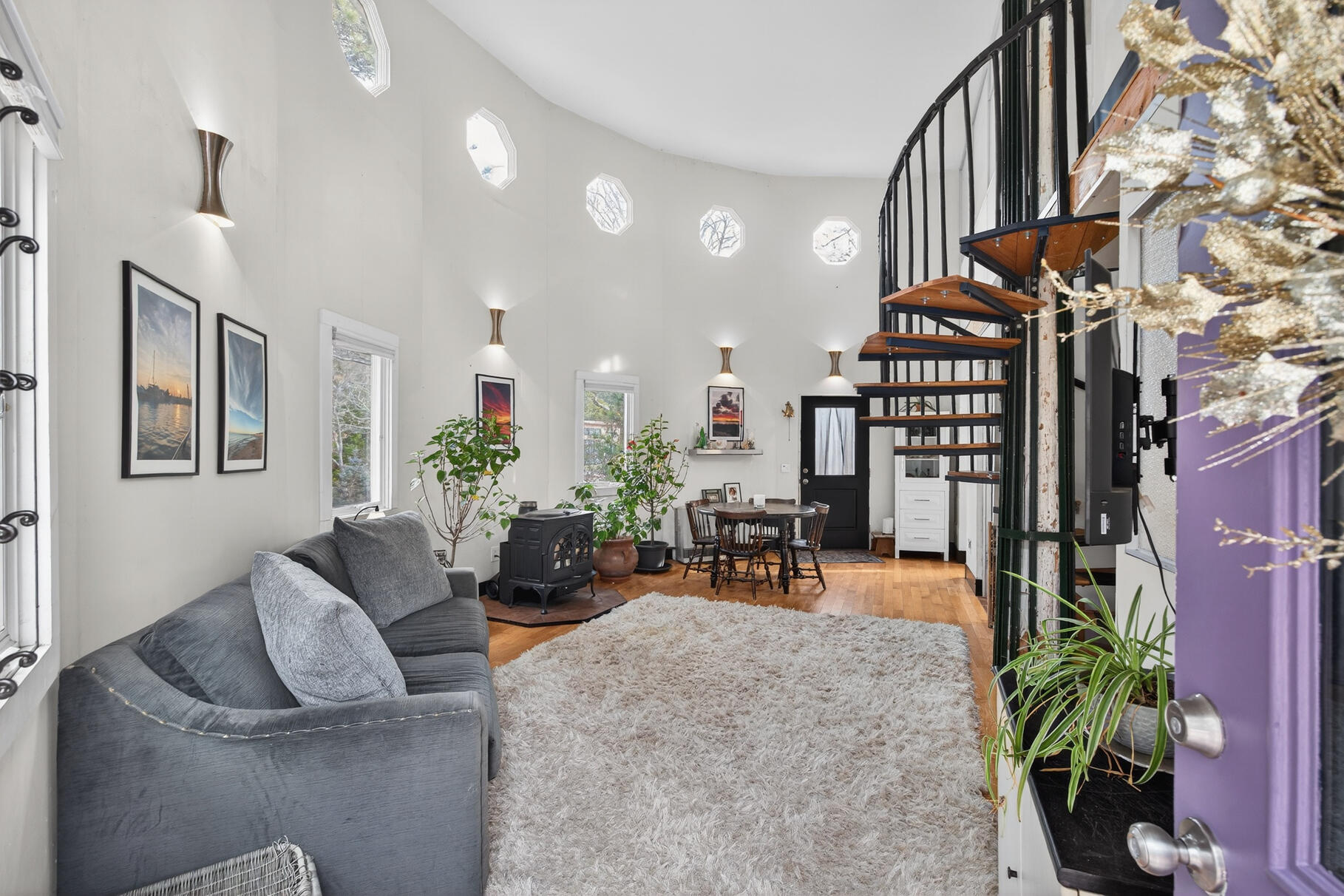 a living room with furniture and a potted plant